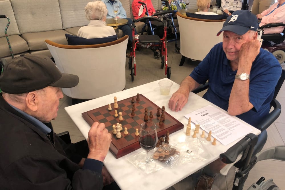 Residents enjoying a chess game together at Anthology of The Arboretum in Austin, Texas